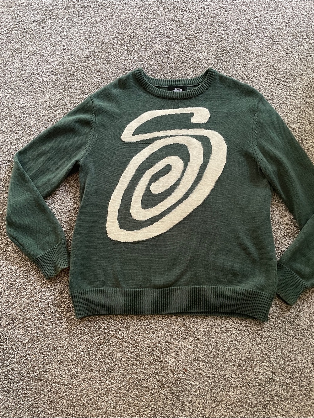 Dark Green Stussy Crewneck Sweater with Cream Spiral Motif